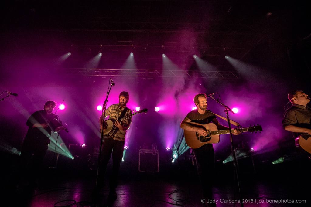Trampled By Turtles under stage lights at Red Wing Roots Music Festival