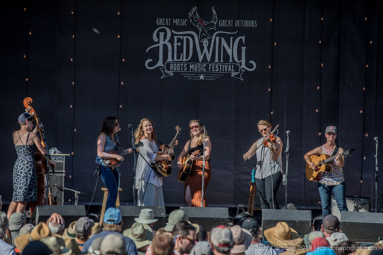 Della Mae and guests performing onstage at Red Wing Roots Music Festival