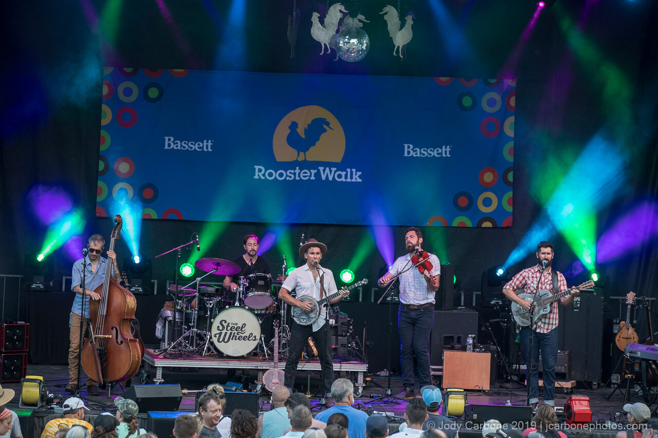 The Steel Wheels under colored lights at dusk, Rooster Walk music festival