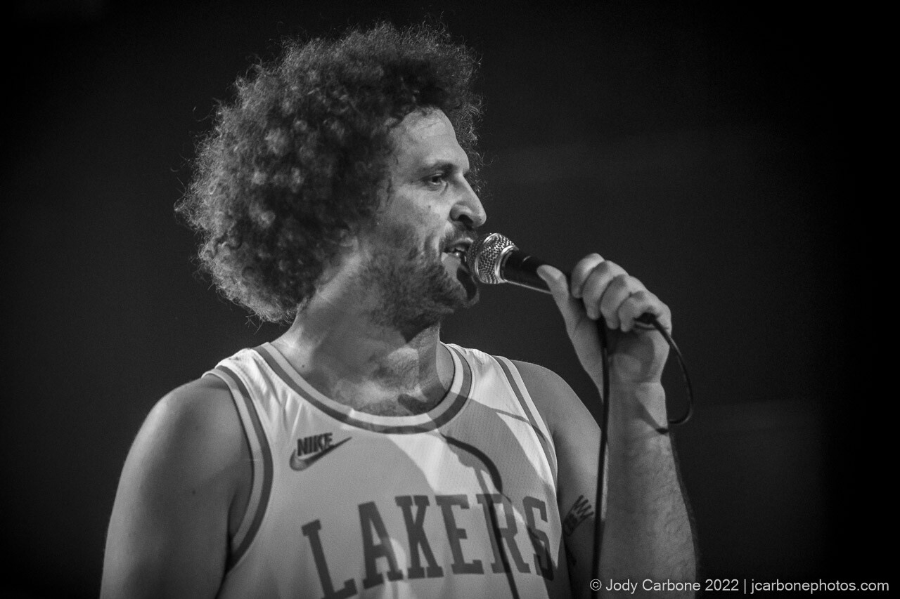 Black and white concert photography - Andy Frasco singing into a microphone