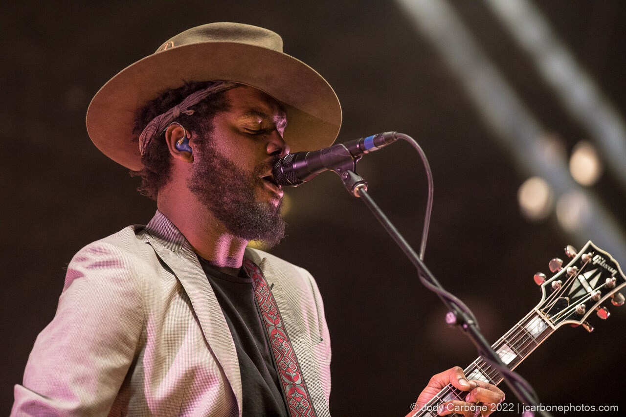 Close up of Gary Clark Jr. singing into a microphone