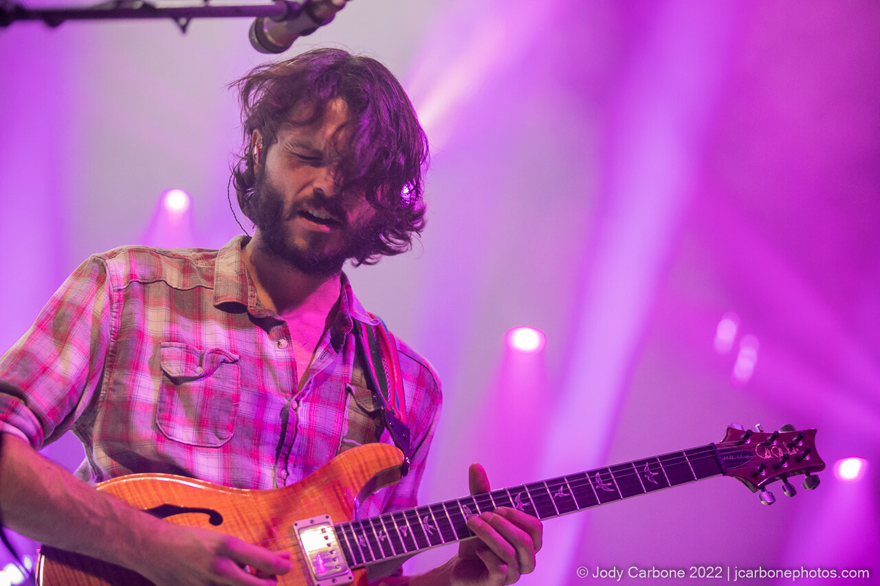 Rick Mitarotonda playing guitar under bright pink lights